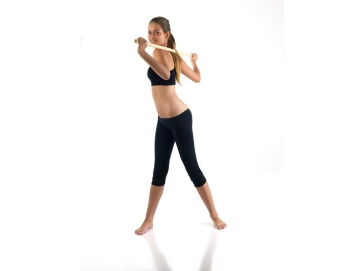 Cane exercise to strengthen and develop back muscles with thoracic osteochondrosis.
